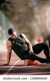 Man Foam Rolling. Athlete Stretches Using Foam Roller.