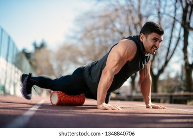 Man Foam Rolling. Athlete Stretches Using Foam Roller.