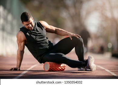 Man Foam Rolling. Athlete Stretches Using Foam Roller.