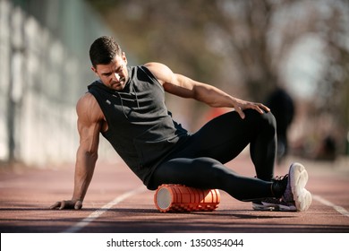 Man Foam Rolling. Athlete Stretches Using Foam Roller.