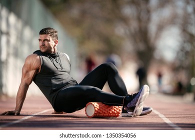 Man Foam Rolling. Athlete Stretches Using Foam Roller.