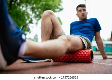 Man Foam Rolling. Athlete Stretches Using Foam Roller.