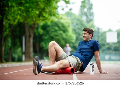 Man Foam Rolling. Athlete Stretches Using Foam Roller.