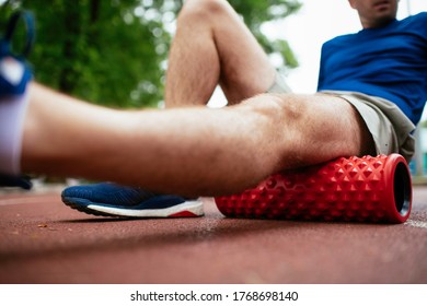 Man Foam Rolling. Athlete Stretches Using Foam Roller.