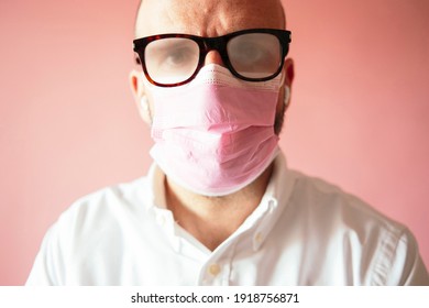 Man With Foggy Glasses Because Of The Pink Mask