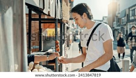 Man, food and street vendor with kebab on travel, walk or tourism for taste test, culture and giving product. Person, customer and shop for snack on metro sidewalk, vacation and urban road in Japan