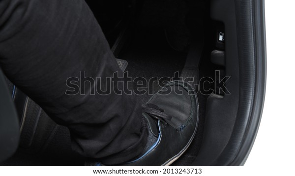 Man foot and accelerator and brake pedal inside\
the car or vehicle and copy space which black color leather shoe\
stepped on it for speed up or control automobile pace power.\
Automobile Driving concept