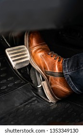 Man Foot On The Break Pedal Of A Car.