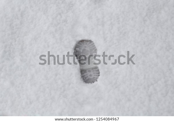 Man footprints in\
a heavy white winter snow