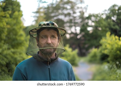 Man In Forest With Hat With Mosquito Net