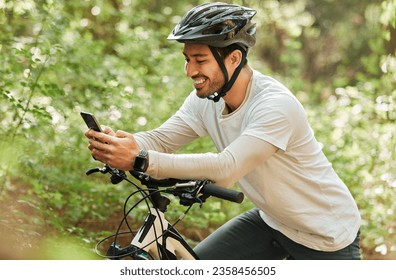 Man, forest and phone on bike, texting and smile for web chat notification on adventure in nature. Guy, cycling and smartphone for contact with bicycle, relax and social media app in woods on blog - Powered by Shutterstock