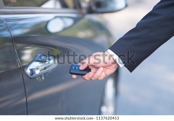 Man\
in formalwear open car door, Hand on car door\
handle