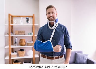 Man With Fractured Hand And Whiplash Pain At Home - Powered by Shutterstock