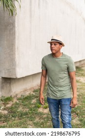 Man With Freckles And Dark Hair, Walking Down The Street Looking Around.