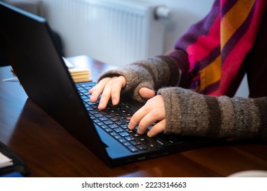 man freezes in office; working in gloves; low temperature at work; cold at home; cold at work; energy crisis 2022; winter 2022; blackout; no heating; energy problems in europe; home office; gas crisis - Powered by Shutterstock