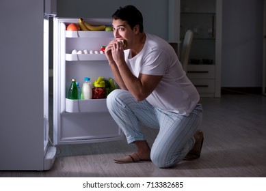 Man At The Fridge Eating At Night