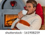 Man in front of a fireplace