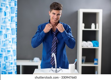 Man Front Of The Mirror In The Bathroom Getting Ready For Work