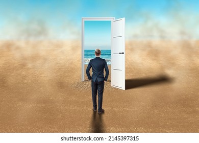A man in front of an open door in the desert. New beginning, new life, vacation, travel, vacation. Door in the desert, access to the beach, blue sea. Hope, dream, goal