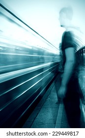 Man in front of a subway train 