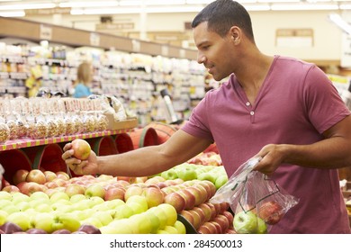Man At Fruit Counter In Supermarket