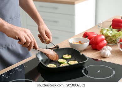 Man Frying Vegetables In Kitchen, Closeup