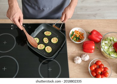 Man Frying Vegetables In Kitchen, Closeup