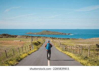 Man full of enthusiasm embarks on his journey along the Fisherman trail - Rota Vicentina along the Atlantic coast of Portugal. Adventurous backpacker hits the road in the spring months.