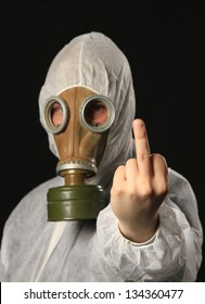 man in full protective clothing wearing a gas mask pointing out middle finger. focus on middle finger