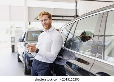 Man Fun Customer Male Buyer Client Wear White Shirt Talk By Mobile Cell Phone Leaning On Car Choose Auto Want Buy New Automobile In Showroom Vehicle Dealership Store Motor Show Indoor. Sales Concept.