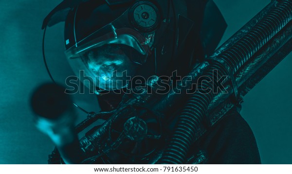 man of the future or\
space with futuristic helmet and fantasy lights, carries a laser\
weapon in his hands