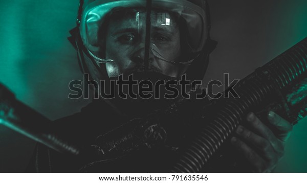 man of the future or
space with futuristic helmet and fantasy lights, carries a laser
weapon in his hands