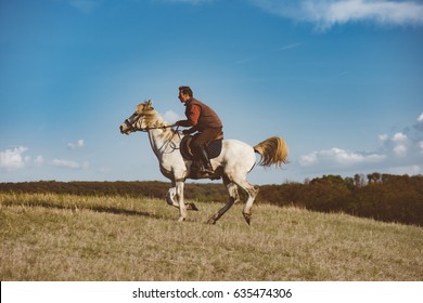 Man Galloping On White Horse