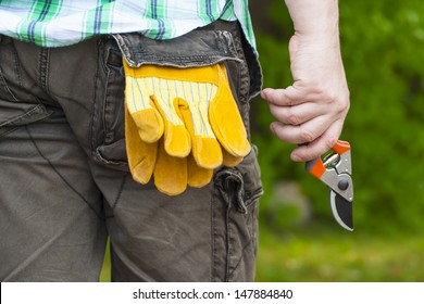 Man with gardening shears in hand
