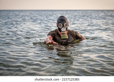 Man In Gas Mask Coming Out Of The Dirty Radioactive Water