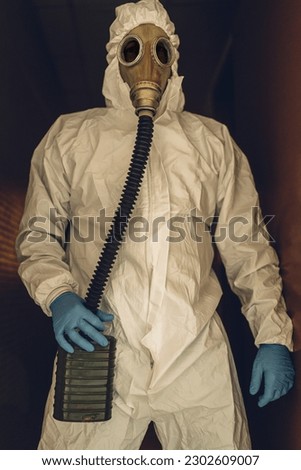 man with gas mask and protective suit