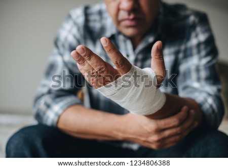 Man with a gauze bandage wrapped around his hand