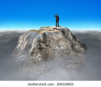 Man Gazing On Top Of Rocky Money Mountain With Cloudy Below