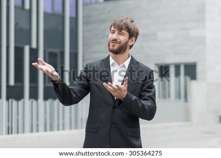 Man is gesticulating while describing plans for company development