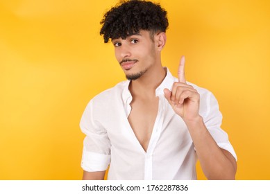 Man Gesturing A No Sign. Closeup Portrait Unhappy, Serious Guy Raising Finger Up Saying: Oh No You Did Not Do That. Standing Over Yellow Background. Negative Emotions Facial Expressions, Feelings.