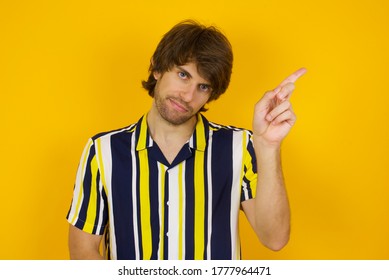 Man Gesturing A No Sign. Closeup Portrait Unhappy, Serious Guy Raising Finger Up Saying: Oh No You Did Not Do That. Standing Over Yellow Background. Negative Emotions Facial Expressions, Feelings.