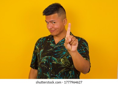 Man Gesturing A No Sign. Closeup Portrait Unhappy, Serious Guy Raising Finger Up Saying: Oh No You Did Not Do That. Standing Over Yellow Background. Negative Emotions Facial Expressions, Feelings.