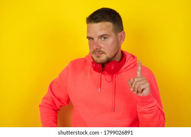 Man Gesturing A No Sign. Closeup Portrait Unhappy, Serious Guy Raising Finger Up Saying: Oh No You Did Not Do That. Standing Over Yellow Background. Negative Emotions Facial Expressions, Feelings.