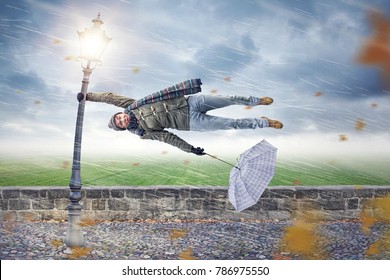 Man gets blown away by a storm - Powered by Shutterstock