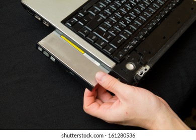 man gets dvd-rom from the computer