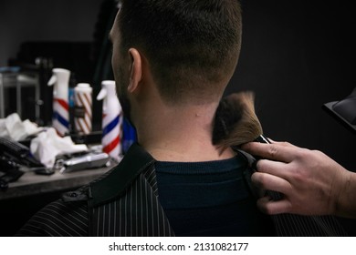  a man gets a haircut in a barbershop