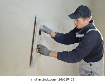 Man Gets Manually Gypsum Plaster On The Wall