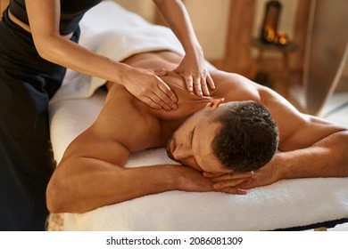 Man getting back massage by masseuse