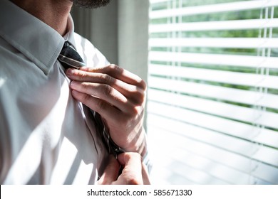 Man getting dressed in bedroom at home - Powered by Shutterstock