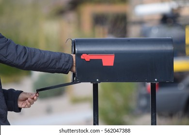 A Man Getting His Mail From A Mailbox